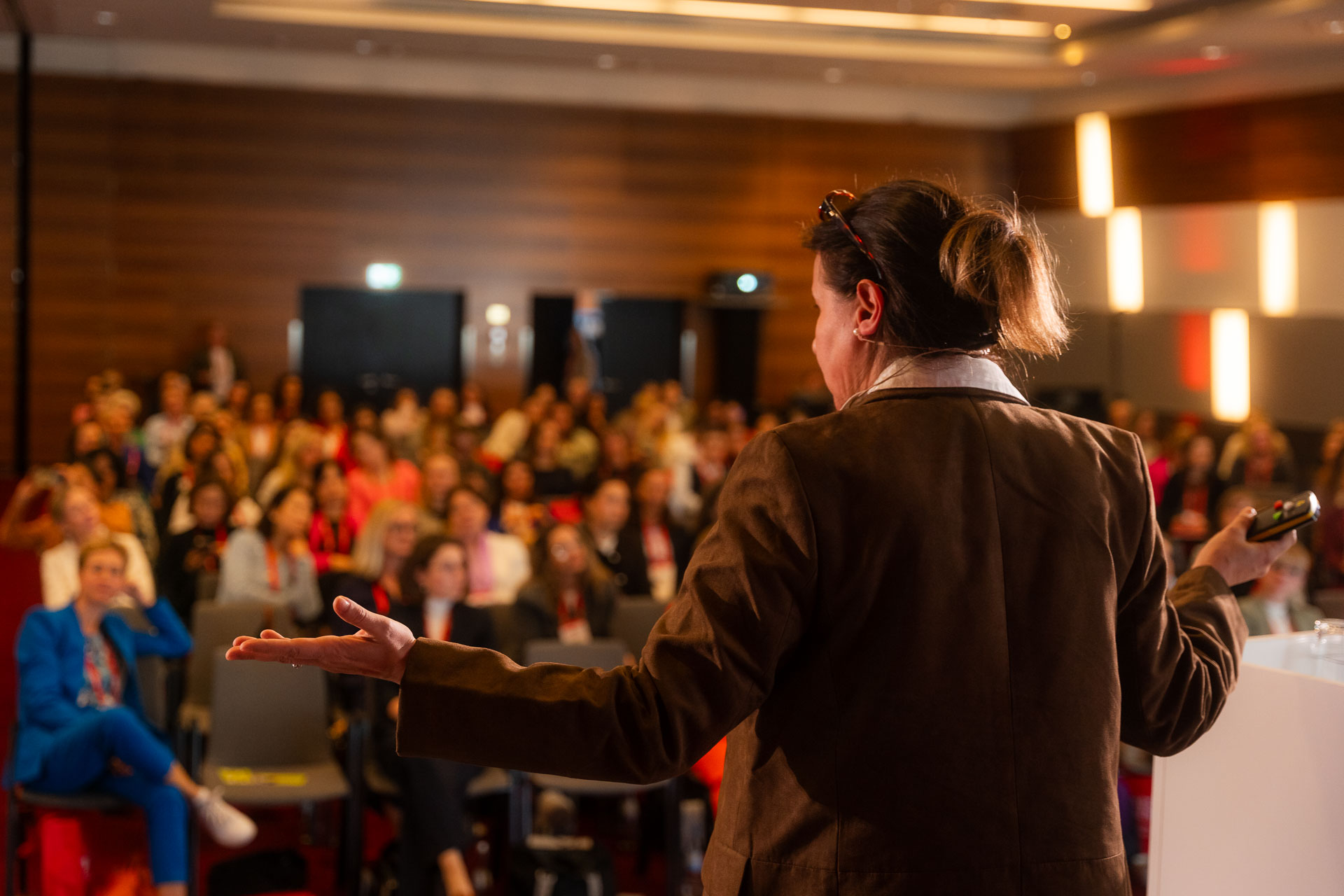Simona Stoytchkova speaking on stage to a full audience